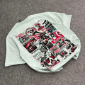 Light grey T-shirt with vintage comic collage graphic design on the back, laid on carpet