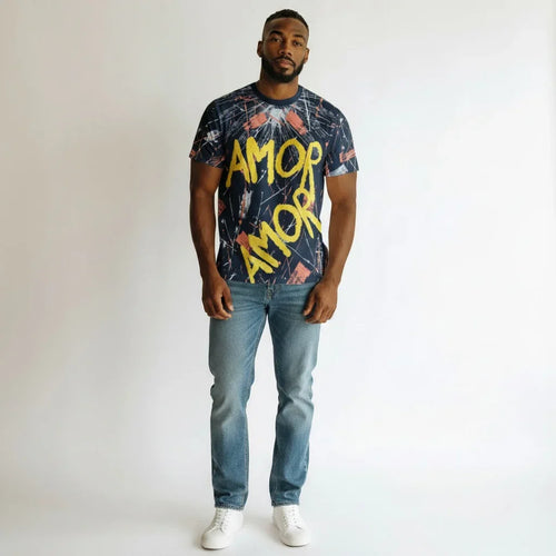 Man wearing graphic t-shirt with 'AMOR' text, blue jeans, and white sneakers on white background