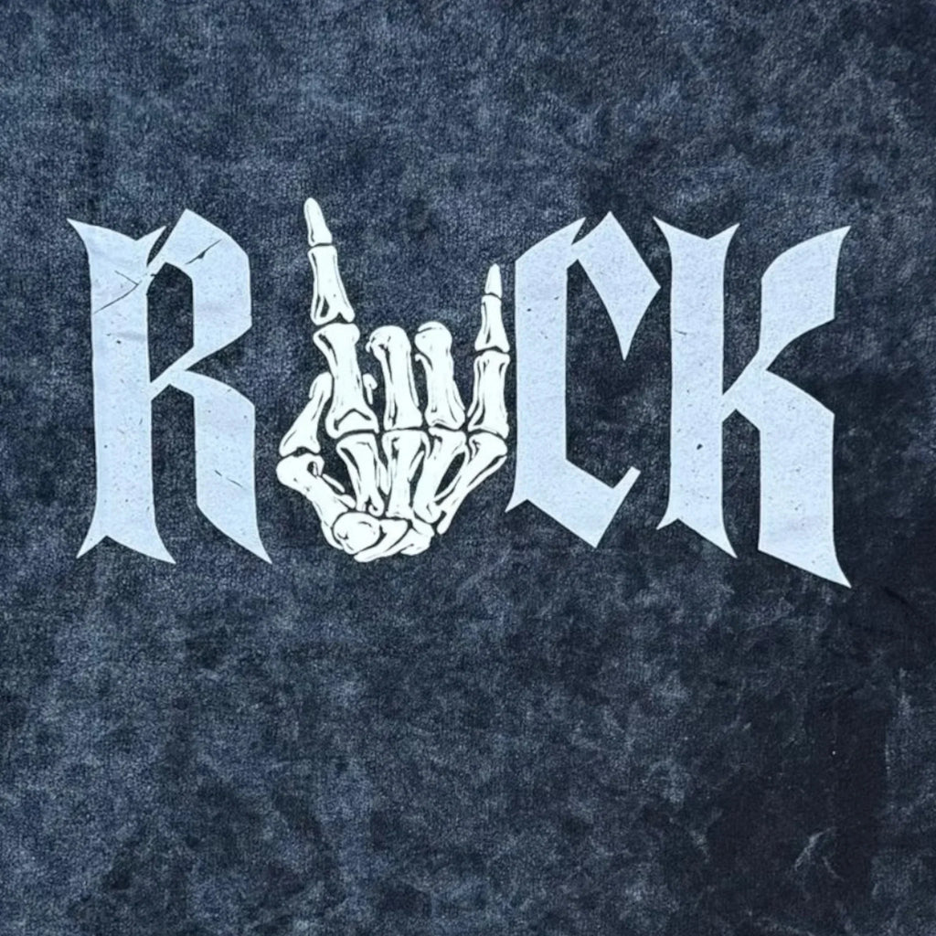Rock graphic t-shirt with skeleton hand making rock sign on black textured background