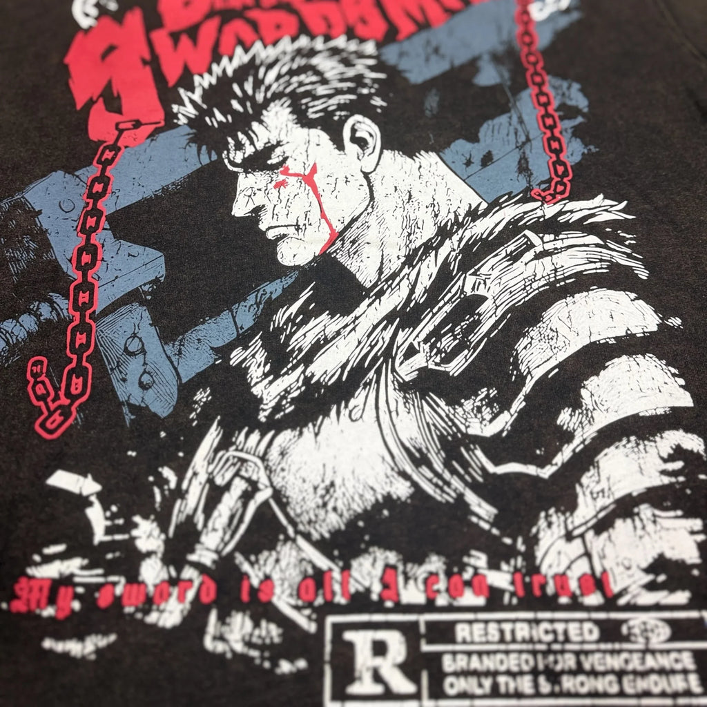 Close-up of graphic tee with dark manga-style warrior, chains, and bold red text accents