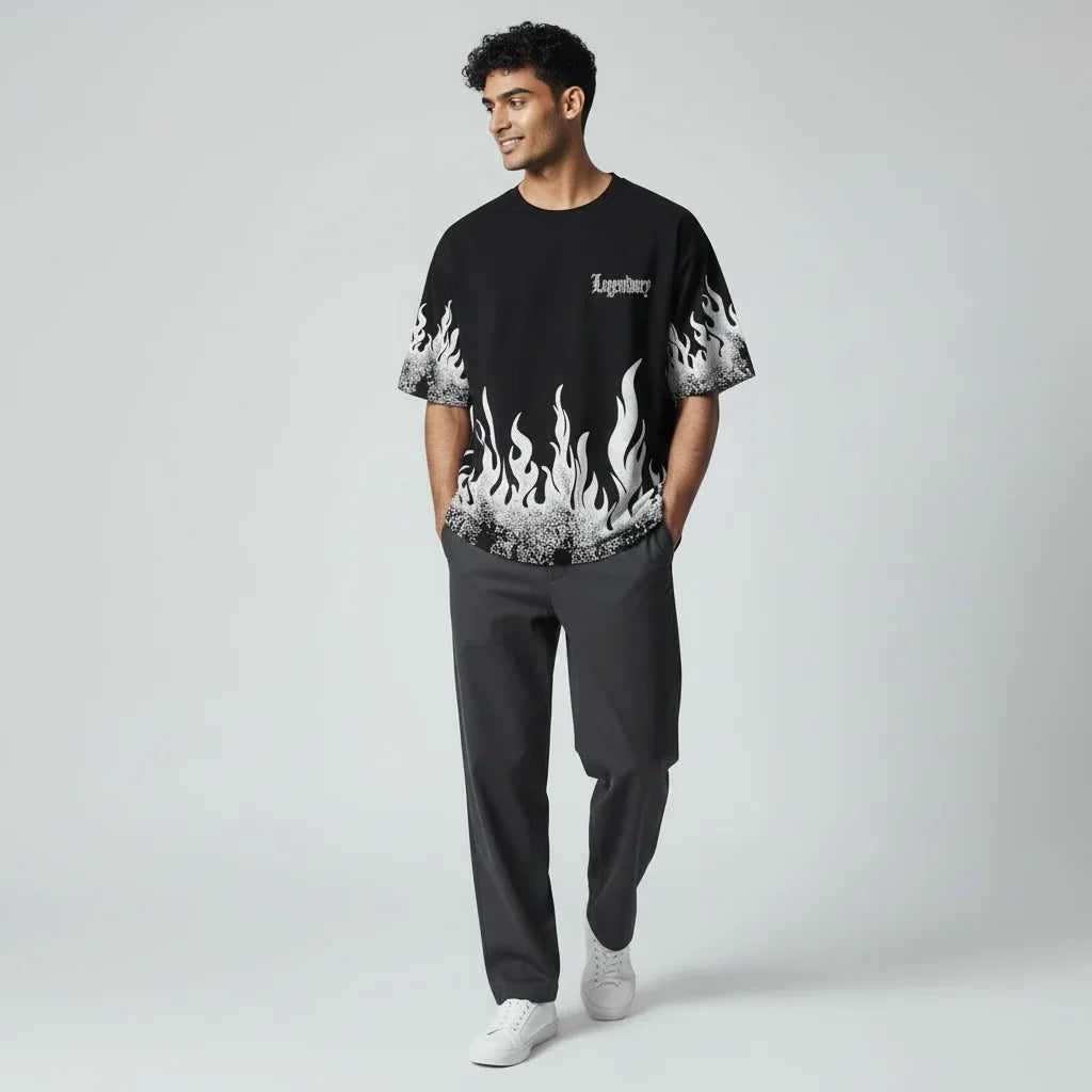 Man wearing black graphic flame t-shirt with 'Legendary' text, dark pants, white sneakers