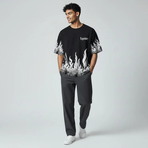 Man wearing black graphic flame t-shirt with 'Legendary' text, dark pants, white sneakers