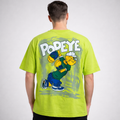 Man wearing lime green T-shirt with Popeye cartoon graphic and bold text on the back